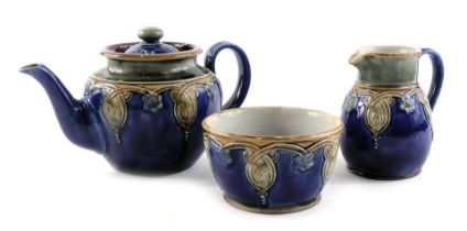 Three Royal Doulton Lambeth wares, comprising a teapot, milk jug, and sugar bowl, stamped 4965.