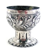 A German silver cup or challis, with embossed decorated of flowers and leaves, on a tapering base, t