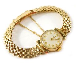 A 9ct gold Helvetia lady's wristwatch, with a small silvered numeric dial, on a three bar bracelet,