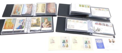 Two albums of first day covers, and two albums containing late 20thC postcards.