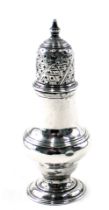 A George III silver pepper pot, with a pierced top, on a fluted body on stepped foot, London 1768, 2
