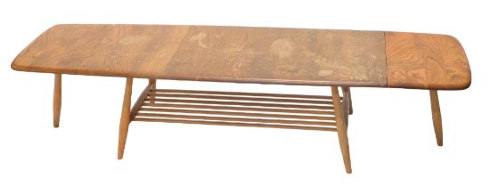 An Ercol elm rectangular drop leaf coffee table, on turned supports, 159cm wide overall.