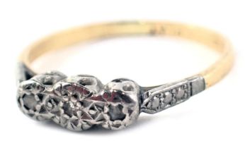 A diamond three stone dress ring, the raised central section set with three tiny diamonds, in platin