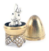 A Stuart Devlin silver parcel gilt Mad March Hare egg, the brushed egg opening to reveal a silvered