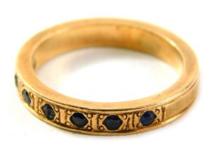 A sapphire half hoop dress ring, set with seven illusion set sapphires, in a rose gold band, yellow