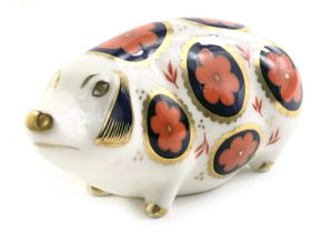 A Royal Crown Derby porcelain pig paperweight, silver button, indistinct red back stamp.