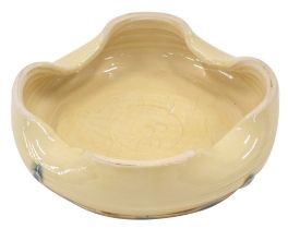 A Fenella Mallalieu studio pottery ashtray, with four point flared rim, applied green circular paint