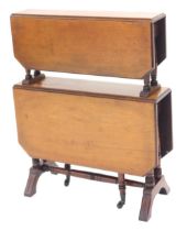 A late Victorian walnut drop leaf two tier dumb waiter, with moulded canted edges, twin turned suppo