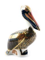 A Royal Crown Derby brown pelican porcelain paperweight, gold button and red back stamp, boxed.