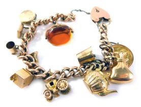 A curb link charm bracelet, set with eleven charms including a George V half gold sovereign dated 19