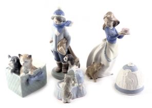 Lladro figure of a child with dog, in evening coat with hat and scarf, 21cm high, a Lladro 1990 Bell