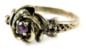 A rose decorated dress ring, of crossover design set with amethyst and CZ stone, on a silver gilt ba