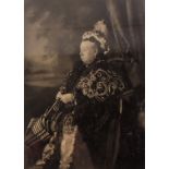 A late 19thC photographic image of Queen Victoria, bearing signature, in an oak frame.