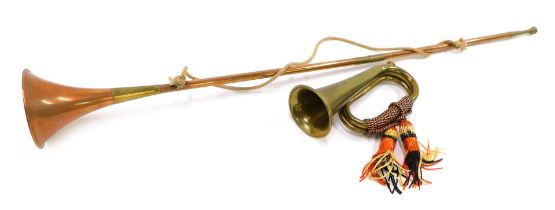 A brass bugle, and a copper and brass hunting horn.