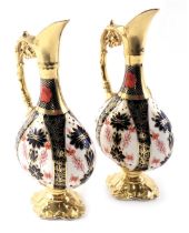 A pair of Royal Crown Derby Imari pattern ewers, with a white and royal blue ground, with gilded