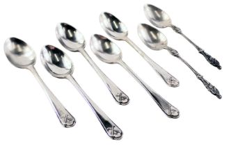 Seven white metal teaspoons, comprising a set of five golfing related teaspoons and two apostle hand