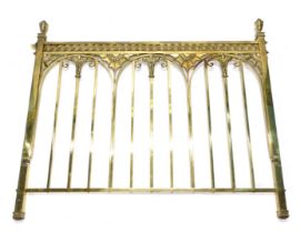 A late 19th/early 20thC brass bed end, cast with roundels, scrolls, etc., 138cm wide.