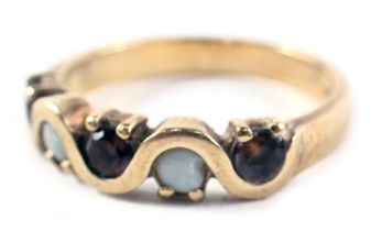 A 9ct gold dress ring, set with five semi precious stones to include three garnets and two opals, wi