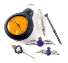 An Ingersoll Triumph pocket watch, in outer rubber casing, with silver pencil case, and two RAF wing