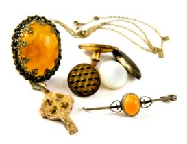 A small group of jewellery, comprising an imitation amber set dress ring, two cufflinks, a bar brooc