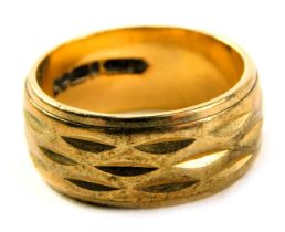 A 9ct gold wedding band, of patterned design, ring size L, 5.6g all in.
