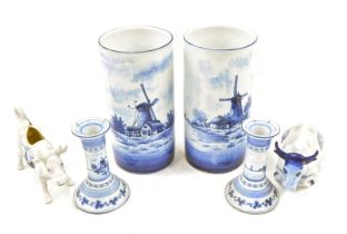 A pair of Delft porcelain cylindrical vases, decorated with windmills, 22cm high, a similar pair of