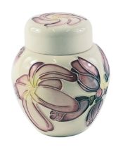 A Moorcroft small jar and cover, on a cream ground with pink and yellow patterned flowers, 12cm high