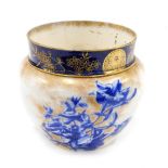 A Royal Doulton ceramic jardiniere, decorated in deep blue with flowers, etc., on a mottled gilt gro