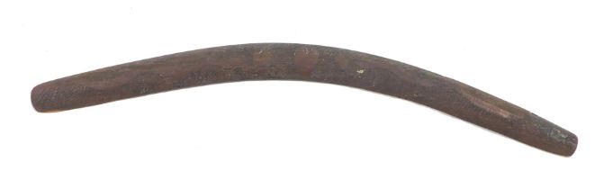 A carved hardwood aboriginal tribal boomerang, decorated with snakes, etc., 76cm wide.