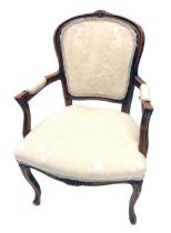 A 20thC French walnut fauteuil, with cream upholstered back, arm rests and seats, on cabriole legs.