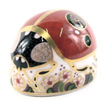 A Royal Crown Derby porcelain ladybird paperweight, gold button and red back stamp, boxed.