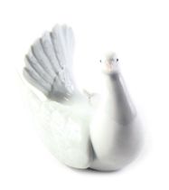 A Lladro figure of a seated dove, 13cm high.