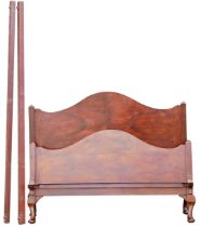 An early 20thC walnut bed head and foot, with arched top, on cabriole legs with pad feet, 138cm wide