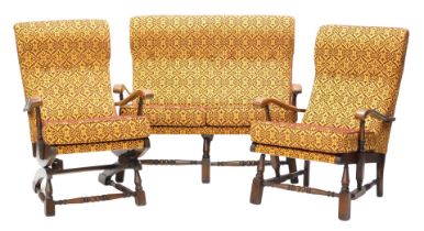 A 20thC beech cottage suite, comprising two seat sofa, armchair and a rocking armchair, upholstered