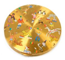 A 1950s gilt metal compact, decorated overall with circus scenes with lions, tigers, strong man, clo