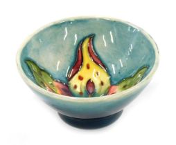 A Moorcroft arum lily pottery bowl, of tapering form, tube line decorated centrally with sauromatum