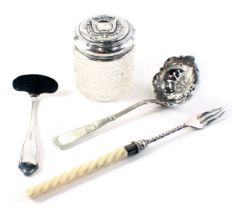 A silver topped and cut glass dressing table jar, silver plated sifter spoon, silver plated food pus