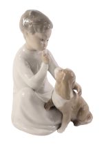 A Lladro figure group, of a seated child with dog, 21cm high.