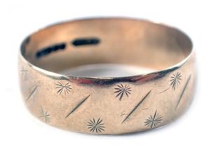 A 9ct gold wedding band, with star and dash design, ring size T, 3.5g all in.