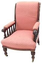 A late 19thC mahogany library armchair, with scroll overstuffed back and arms and T shaped seat, on