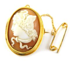A 19thC shell cameo brooch, the oval cameo with raised relief figure of a maiden, in a bloomed gold