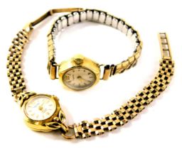 A Rotary lady's wristwatch, with a silvered dial, on three bar bracelet on a 9ct gold strap, in a ye