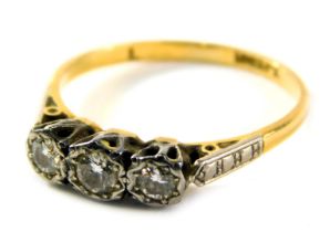 An Edwardian three stone diamond dress ring, set with three illusion set round brilliant cut diamond
