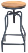 A modern industrial style adjustable stool, with hardwood seat and blue painted tubular frame.
