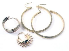 A pair of hoop earrings, yellow metal stamped 375, a single hoop earring and star earring, each yell