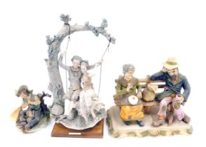 An Armani ceramic figure group of two people on swings, a Capodimonte group of tramp and a lady on a