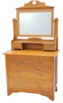 A late Victorian walnut dressing chest, the raised back with a rectangular mirror plate, the base wi