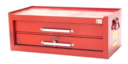 A small Snap On style two drawer tool chest, painted red, with side handles, label stamped Made in C