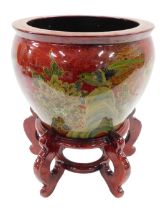 A modern Chinese porcelain jardiniere, decorated with exotic birds, flowers, etc., on a mottled red
