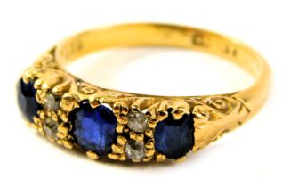 An Edwardian sapphire and diamond dress ring, set with three oval sapphires, in claw setting with fo